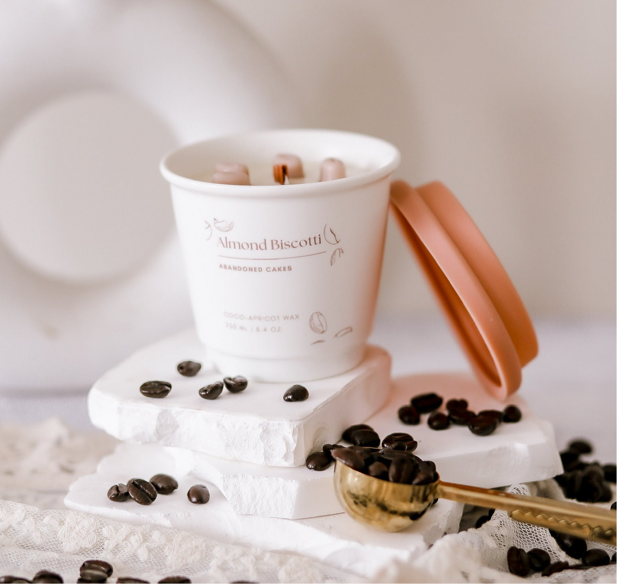 •	“Almond Biscotti Candle in ceramic to-go cup by Abandoned Cakes with cozy bakery-inspired scent”
	•	“Hand-poured almond and vanilla candle styled in café-inspired setting”