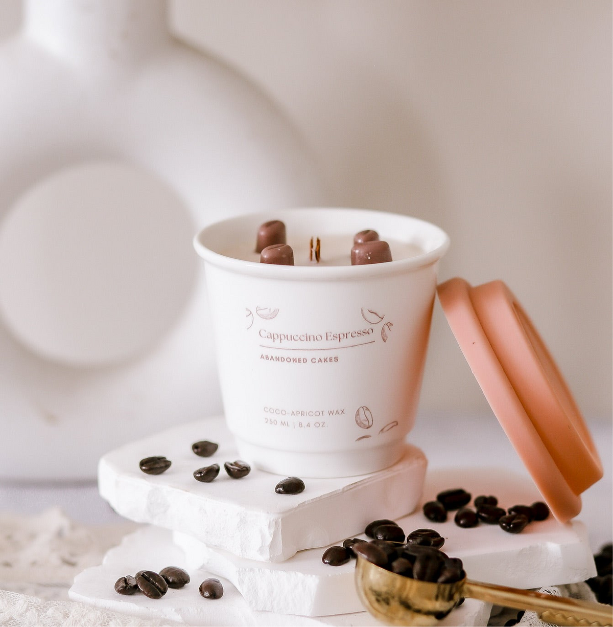 “Cappuccino Espresso Candle in ceramic to-go cup by Abandoned Cakes with espresso and chocolate notes”
	•	“Hand-poured espresso scented candle with cozy coffee shop style”