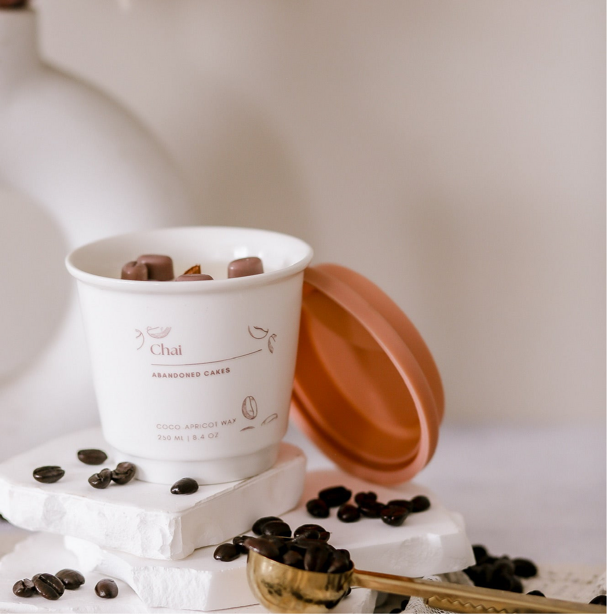 •	“Chai Candle by Abandoned Cakes in ceramic to-go cup with cozy spiced vanilla notes”
	•	“Creamy chai-scented candle styled with warm neutral decor and coffee beans”